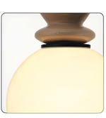 Close-up of a lamp with a glass shade and metallic base on a white background