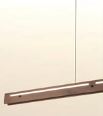 A modern linear LED pendant light with a dark wood-grain finish and a thin black suspension cord, shown against a plain off-white background.