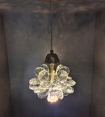 Gold pendant light fixture hanging from a ceiling