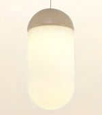 A modern cylindrical pendant light with a frosted white glass shade and a metallic taupe-gray dome-shaped top, shown against a plain off-white background.