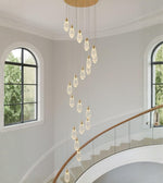Crystal drop cascade staircase chandelier with modern teardrop pendants in a double height interior