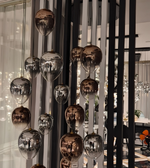 Decorative hanging lights with reflective globes in a modern interior setting.