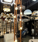 Display of various chandeliers and ceiling lights in a store setting.