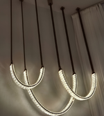 Modern pendant lights hanging from the ceiling with a neutral background.