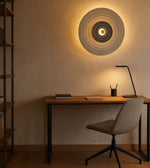 Modern home office with minimalist desk, stylish chair, and circular wall light decor
