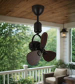 Decorative mini ceiling fan with wooden blades installed in a balcony sit-out area