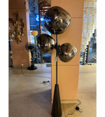 Modern smoked glass cluster floor lamp with black stand placed beside sofa in contemporary living room