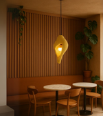 Contemporary pendant light in yellow, sculpted foam design with ambient lighting for modern interiors, cafes, and bedrooms.
