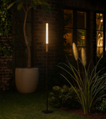 Outdoor LED path light with slim pole design in landscaped garden