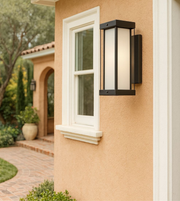 Vertical outdoor wall light with frosted glass on a modern exterior wall.