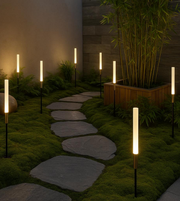Outdoor pathway spike lights illuminating garden stepping stones at night