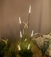 Modern outdoor bollard light illuminating garden