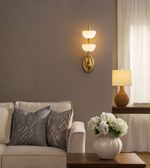 Designer gold wall sconce in an elegant living room setting.