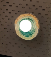 Daya Worldwide TERRA RING wall sconce, modern wall light with circular design, mounted on a wall with soft ambient lighting.