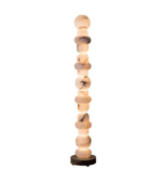 Sculptural marble effect floor lamp with stacked design on white background