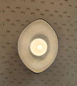 Decorative wall light fixture on a textured wall
