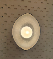 Decorative wall light fixture on a textured wall