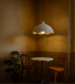Modern Earth Wave pendant lamp in grey textured finish above a cozy seating area