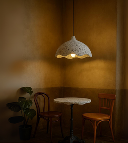Modern Earth Wave pendant lamp in grey textured finish above a cozy seating area
