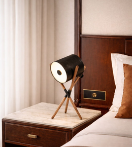 modern tripod spotlight table lamp with black cylindrical shade and wooden crossed legs, decorative bedside lighting