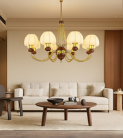 Elegant Aurelía Classic Chandelier by Daya Worldwide with crystal accents and ornate gold detailing, hanging from a decorative ceiling.