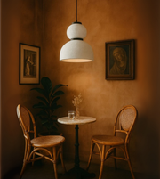 Nordic Glow all-white sculptural pendant light above wooden furniture