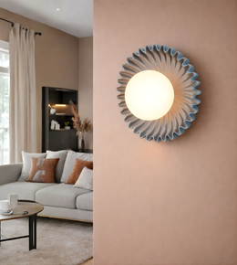 Blue pleated disc wall light with central opal globe mounted on interior wall