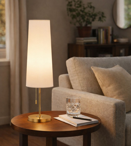 elegant cream fabric shade table lamp with brass finish and warm ambient glow for modern living room