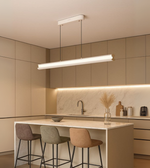 Arcus Linear pendant light in matte white illuminating a contemporary kitchen.