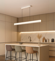 Arcus Linear pendant light in matte white illuminating a contemporary kitchen.