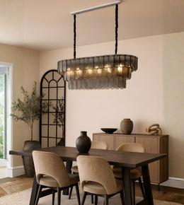 Smoked glass scallop dining chandelier with warm lighting above a modern dining table interior
