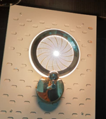 Luxury gold spiral wall lamp creating infinity light pattern on designer wall