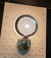 Luxury gold spiral wall lamp creating infinity light pattern on designer wall