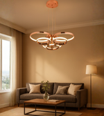 Nova Rings chandelier with gold finish illuminating beige-toned modern living space.