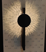 Black and gold wall light by Daya Worldwide, featuring a sleek modern design with a luminous glow.