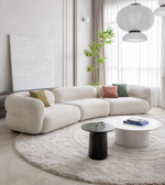 Daya Worldwide Curve Sofa with plush fabric upholstery and modern design, showcasing its sleek, curved shape and comfortable seating.
