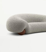 Curved boucle sofa from Daya Worldwide, featuring plush fabric and modern design, ideal for stylish living room seating.