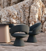 Sculpted dining chair with ergonomic design and wooden legs, featuring smooth curves and a modern aesthetic by Daya Worldwide.