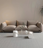 Daya Worldwide Mora Lounge Sofa with plush cushions and modern design, shown in a cozy living room setting.