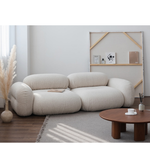 Daya Worldwide Lumo Curve modular sofa with sleek curves and plush cushions, in a modern living room setting.