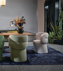 Round back dining chair with wooden legs and upholstered seat, designed for comfortable dining room seating.