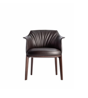 Soren leather dining chair with sleek design and cushioned seat, featuring sturdy wooden legs and modern aesthetic.