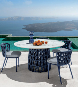 Outdoor dining set by Daya Worldwide featuring a table and chairs for outdoor patio gatherings.