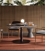 Outdoor dining table from the Bellagio outdoor set by Daya Worldwide, shown with a sleek surface and surrounding chairs.