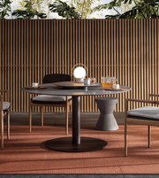 Outdoor dining table from the Bellagio outdoor set by Daya Worldwide, shown with a sleek surface and surrounding chairs.