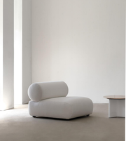 Daya Worldwide Nova lounge chair with a sleek modern design, featuring plush cushions and wooden legs in a contemporary living space.