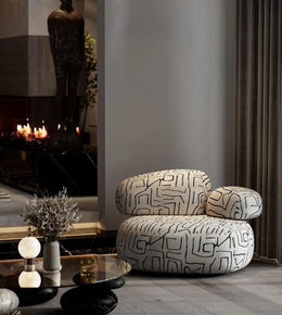 Cozy Daya Worldwide lounge poof in neutral fabric, versatile armchair perfect for relaxing or casual seating in modern living rooms.