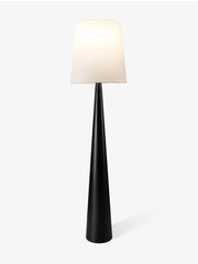 Modern black tapered floor lamp with white fabric shade on a white background