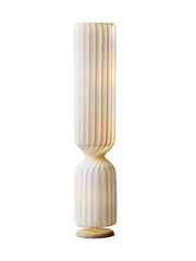 Isolated view of twisted ribbed floor lamp on white background