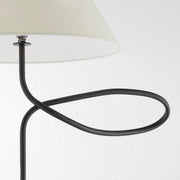 Close-up of sculptural loop arm detail on modern floor lamp